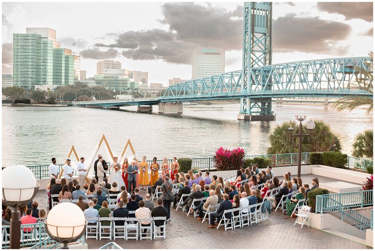 Waterfront ceremony with bridge in background