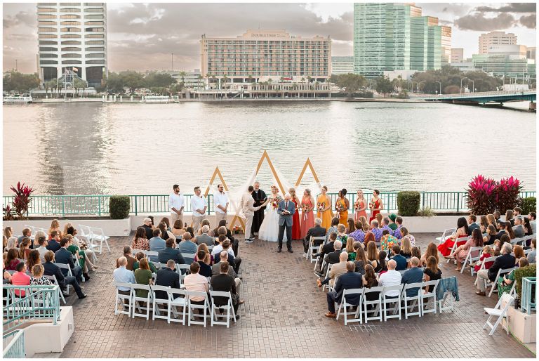 Waterfront ceremony with bridge in background