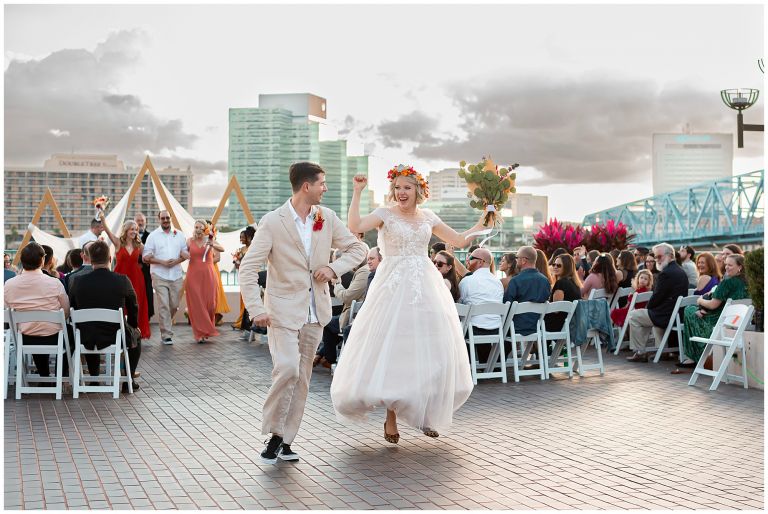 Waterfront ceremony with bridge in background